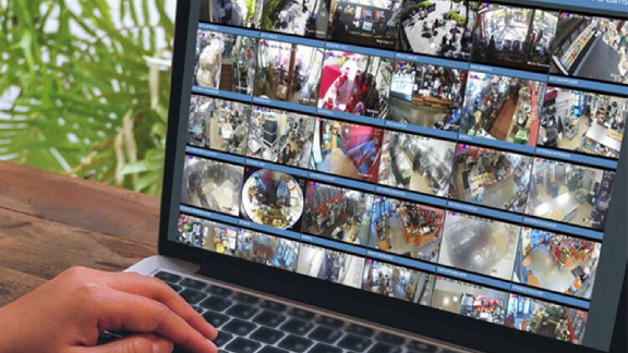 Close-up of a person's at the laptop displaying the cctv footages